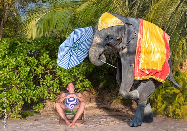 Obraz On a tropical beach, an elephant carries a parasol to a man in a retro swimsuit