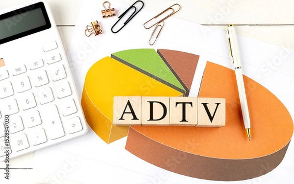 Fototapeta ADTV abbreviation on wooden blocks with pie chart, calculator, pen and paper clips on white office desk