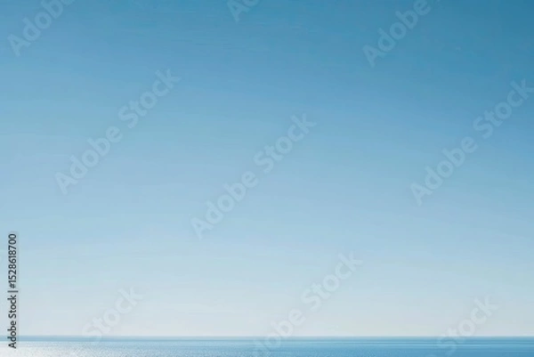 Obraz Clear, bright azure sky meeting a tranquil, flat expanse of blue ocean