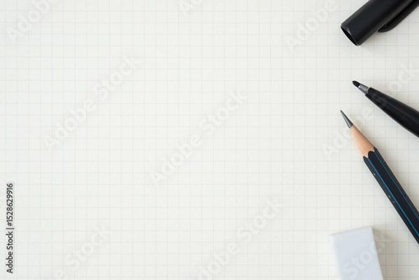 Fototapeta Top view, Close-up of Black Felt-tip Pen, Pencil and Eraser on Graph Paper Background, Copy Space for Text, Flat Lay Concept.