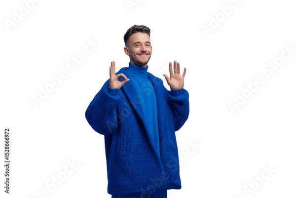 Obraz A man in a blue jacket is smiling and making a peace sign with his hands