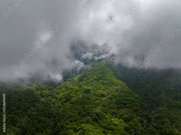 Fototapeta Clouds over the mountain slopes with rainforest in Camiguin Island. Philippines. view from above.