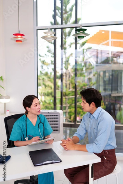 Obraz Healthcare Consultation: A dedicated female medical professional discusses health concerns with a patient in a modern clinic setting, fostering trust and open communication.