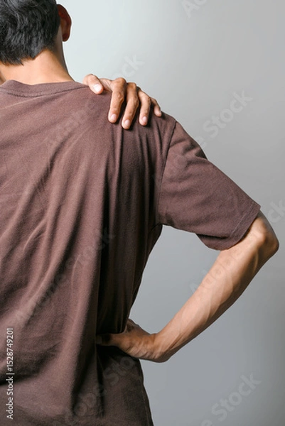 Fototapeta Portrait of a man suffering shoulder pain isolated over a white background. Concept of healthcare