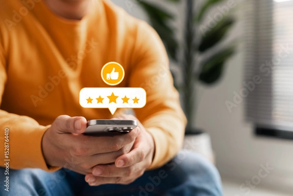 Fototapeta Customer feedback on digital satisfaction, young man uses smartphone to leave 5-star rating and like icon, which represents online feedback, user experience, and brand reputation.