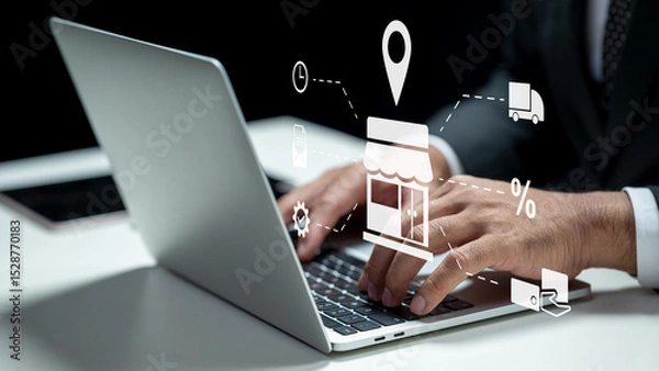 Fototapeta Businessman using a laptop while showing an icon of a shop for ecommerce. Tablet on the table. Technology innovation on a virtual screen. Concept of ecommerce or small business