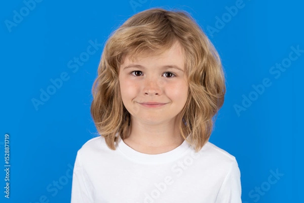 Fototapeta Close up portrait of cute smiling child, isolated studio background. Happy kid, happy and smiling emotions.