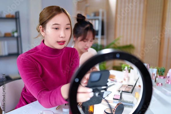 Obraz Asian Women Beauty Blogger Live Streaming Makeup Tutorial Using Ring Light and Smartphone for Beauty Tips and Tricks Online Content Creation and Social Media Marketing