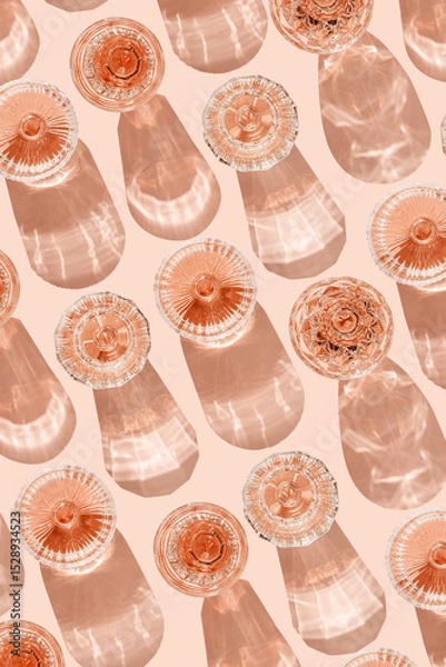 Obraz Stylish flat lay of rose wine crystal glasses casting shadows on pastel peach background. Minimal Top view sparkling alcohol drinking, champagne drinks at sun, wine aesthetic party concept
