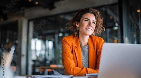 Fototapeta confident women reviewing project data by large office window 