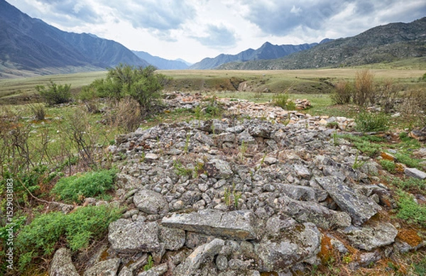 Fototapeta Ancient burials in the Altai mountains on terrace of the Katun and Bolshoy Yaloman rivers.