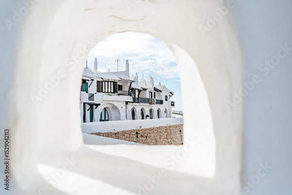 Fototapeta Iconic White Architecture Of Binibeca Vell Village Seen Through An Archway. Menorcan Coastal Town, Whitewashed Houses, Balearic Islands Travel