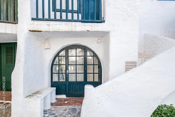 Fototapeta Classic Whitewashed Architecture In Binibeca Vell With Arched Door And Staircase. Menorcan Coastal Village, Traditional Design, Spanish Island Charm