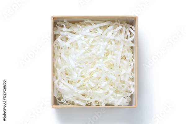 Fototapeta Brown gift box with shredded paper on white background. Top view