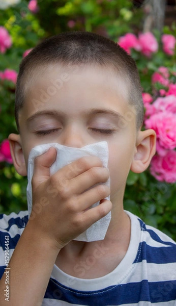 Fototapeta Child Sneezing from Flower Allergy. Selective focus