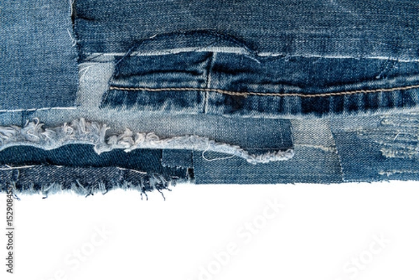 Fototapeta Piece of torn denim on a white background. Denim texture