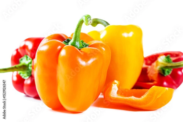 Fototapeta Mix of colorful whole and sliced ​​bell peppers. Isolated on white background.
