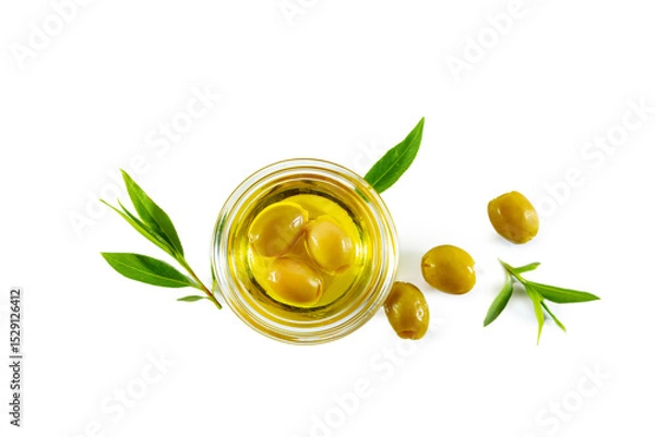 Fototapeta Extra virgin olive oil in a transparent bowl and green olives with leaves.