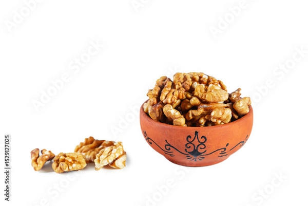 Fototapeta Heap of walnuts in clay bowl isolated on white background.