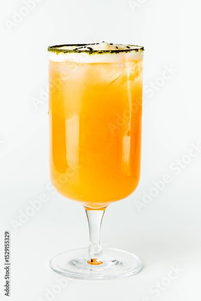Fototapeta A vibrant orange cocktail in a tall clear glass with a salted rim, garnished with black sesame seeds. The drink is refreshing and visually striking, isolated on a white background.
