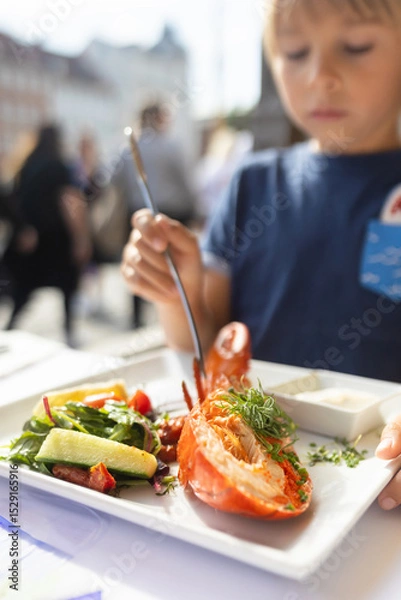 Obraz Family with children, having lunch in a restaurant in Coppenhagen, eating local fish and lobster thermidor with salad and fries