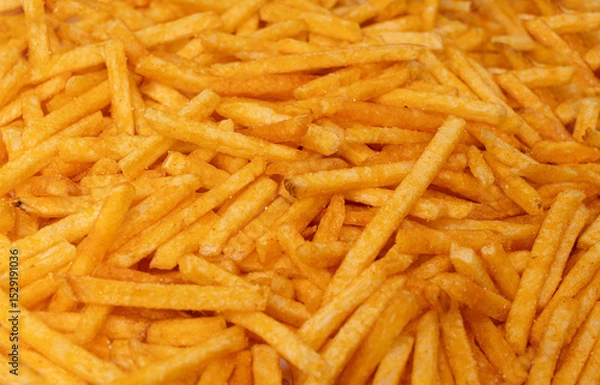 Obraz Fried chips sticks texture background, finger potato ketchup flavored chips pattern, shoestring fries
