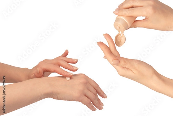 Obraz Beige cream tube in woman hands isolated on a white background. Cream swatch on woman hand.