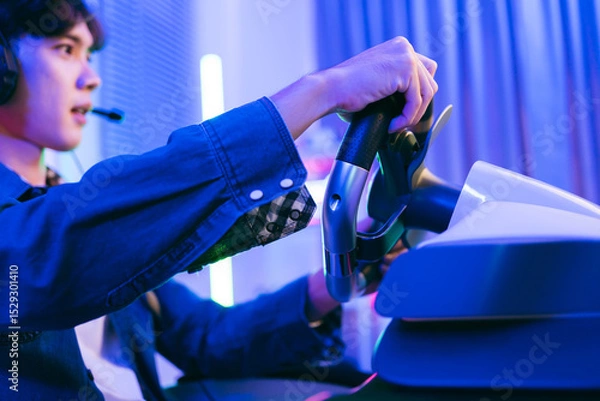 Fototapeta Young gamer intensely plays a racing simulation using a high-end steering wheel controller at home. LED lights and gaming setup create a vibrant esports environment ideal for stock content.