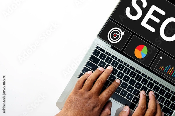 Obraz Top view of hands typing on a laptop with an SEO dashboard on screen. Concept for Search Engine Optimization strategy, data analysis, keyword research, and improving website ranking.