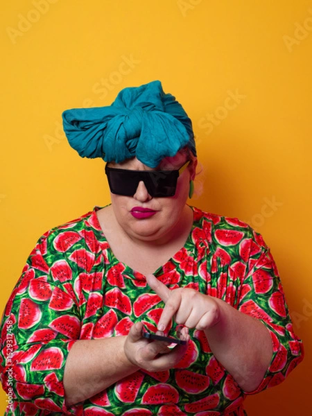 Fototapeta Surprised plus-size woman looking at smartphone with wide expression