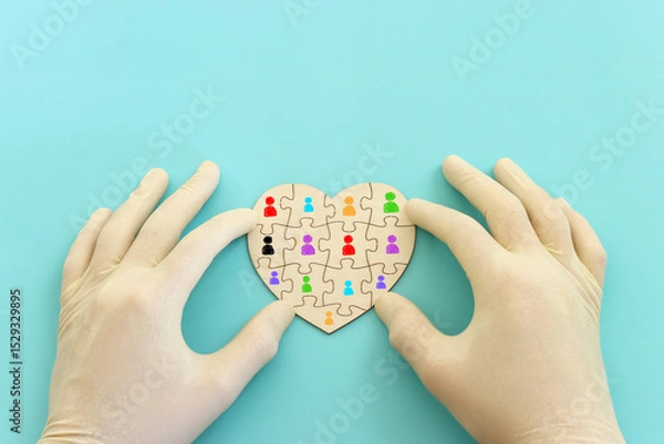 Fototapeta Top view image of doctor or nurse with gloves and puzzle pieces over blue background