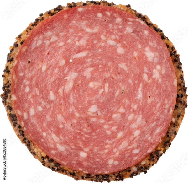 Obraz Peppered salami slice on a wooden board