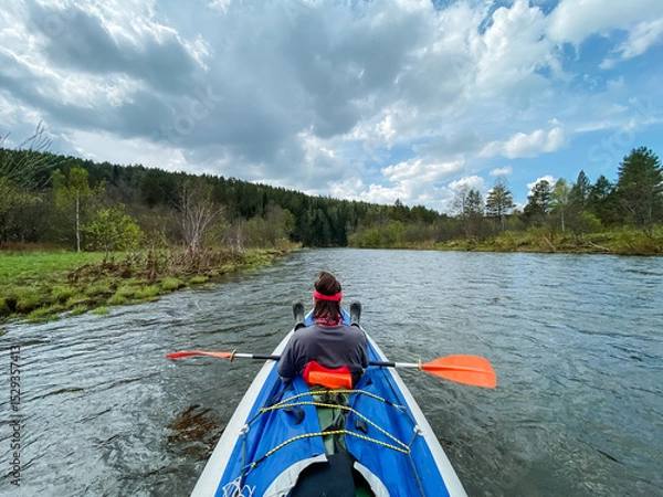 Obraz A person expertly paddles a vibrant kayak down a lively river, enjoying the breathtaking scenery and excitement of this joyful, adventurous activity that brings relaxation