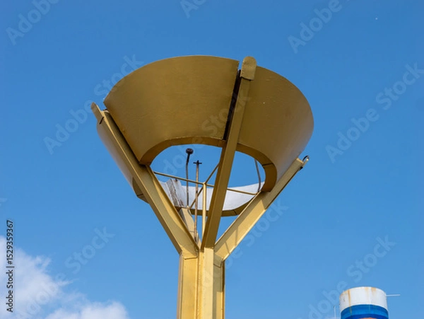 Fototapeta A tall gold colored structure with a dome on top