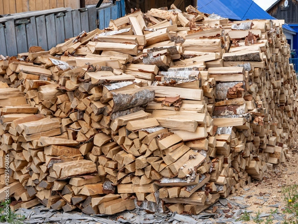 Fototapeta A pile of wood logs stacked on top of each other
