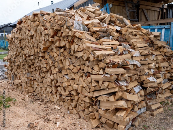 Fototapeta A pile of wood logs stacked on top of each other