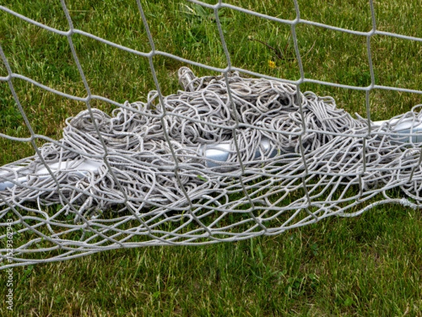Fototapeta A soccer net with a bunch of strings on it