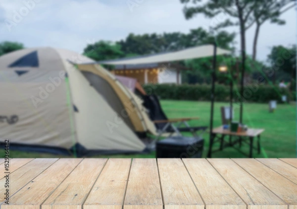 Fototapeta Wooden table top on camping ground mountain and grass field.Fresh and Relax concept.For montage product display or design key visual layout.View of copy space.
