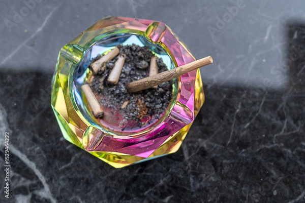 Obraz Colorful Ashtray With Remnants Of Cannabis Joints On A Marble Table