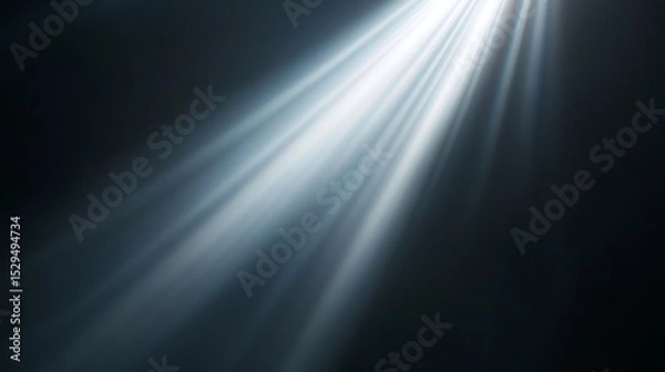Fototapeta Bright rays of light stream across a dark background, simulating a dramatic sunbeam or lens flare effect