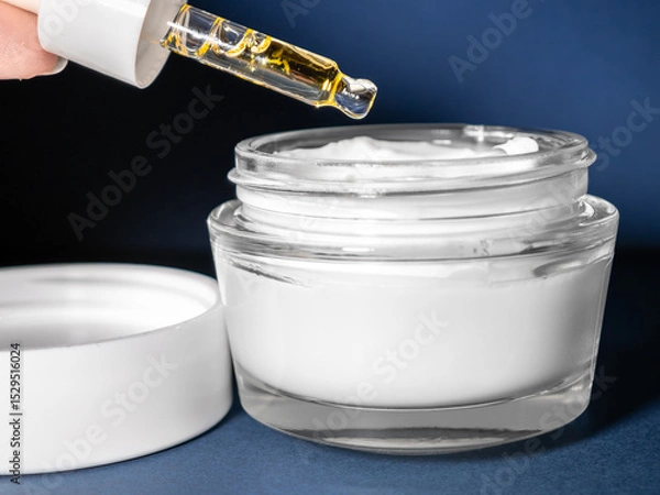 Obraz Add a drop of oil to the cream, make the cream close-up