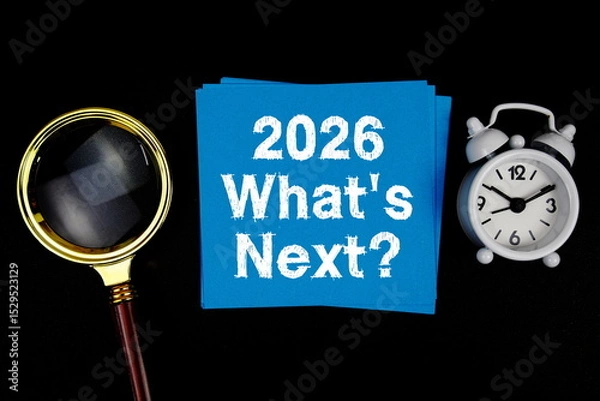 Fototapeta 2026 What's Next? text with magnifying glass and alarm clock on black background