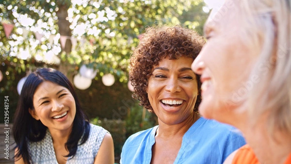 Obraz Close Up Of Smiling Mature Female Friends Socializing In Backyard Together