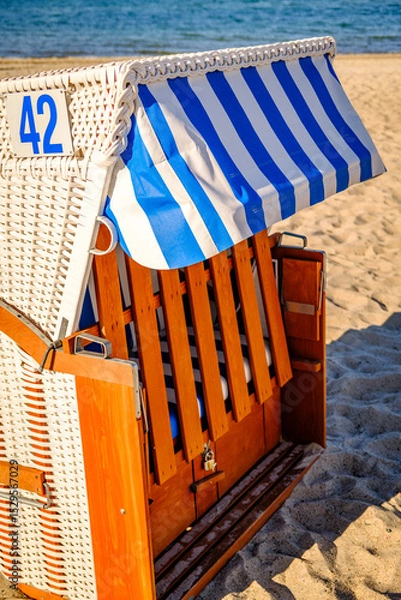 Fototapeta Beachside cabins lined on a sunny day showcasing vibrant colors and clear skies in a coastal location