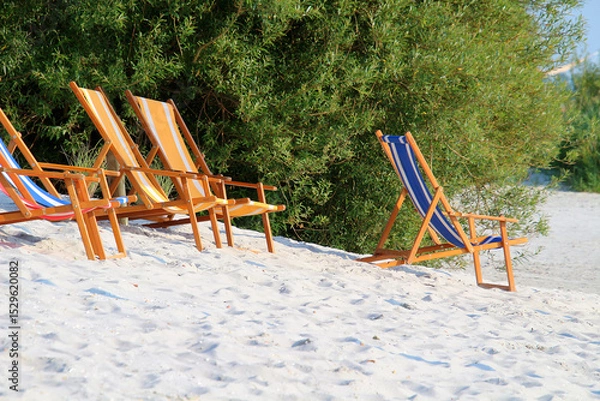 Fototapeta Deckchairs at white sandy beach, summer scene (IJsselmeer, Frisia, Netherlands)