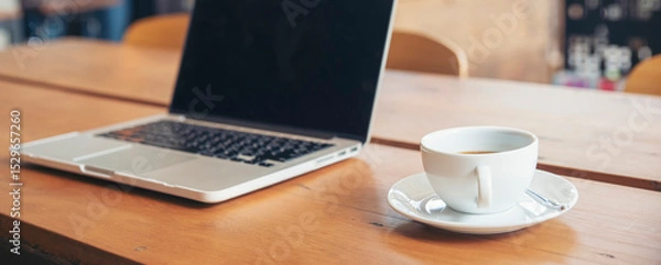 Fototapeta Home Office Desk Concept.Laptop and cup of coffee placed on wooden desk-computer for planner to plan job, working space at home-banner image.