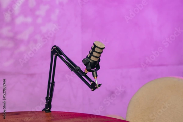 Fototapeta Engaging podcast setup featuring a microphone and headphones in a vibrant atmosphere
