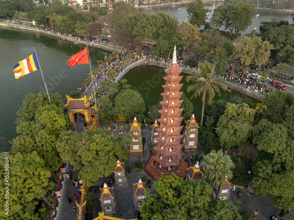 Fototapeta Exploring Tran Quoc temple in Hanoi amidst vibrant surroundings and historical architecture in Vietnam