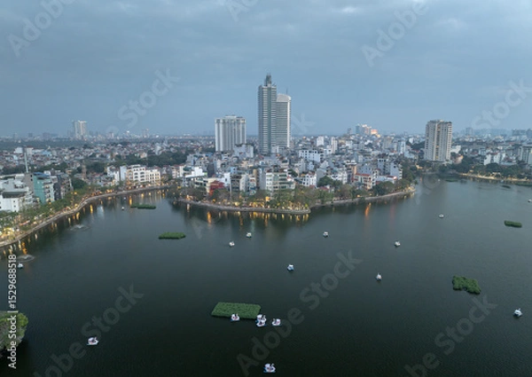 Fototapeta Beautiful view of West Lake in Hanoi city Vietnam during twilight with boats floating peacefully on the calm waters