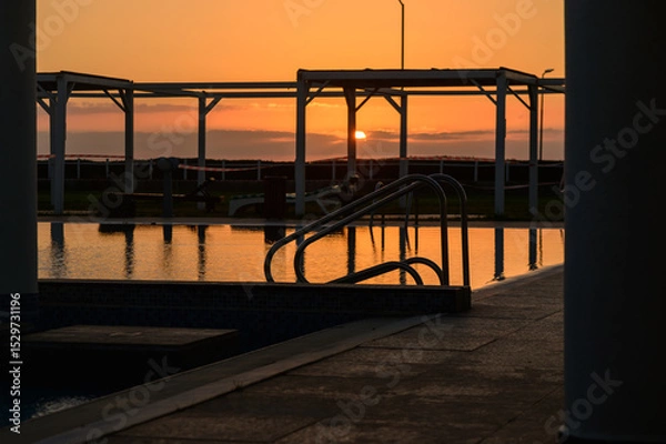 Obraz Golden Sunset Reflected in Pool Water at Mediterranean Resort